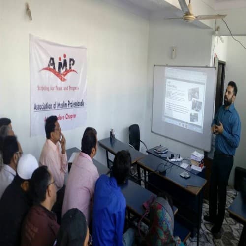 Presenter leading an AMP Ahmedabad Chapter workshop for seated members